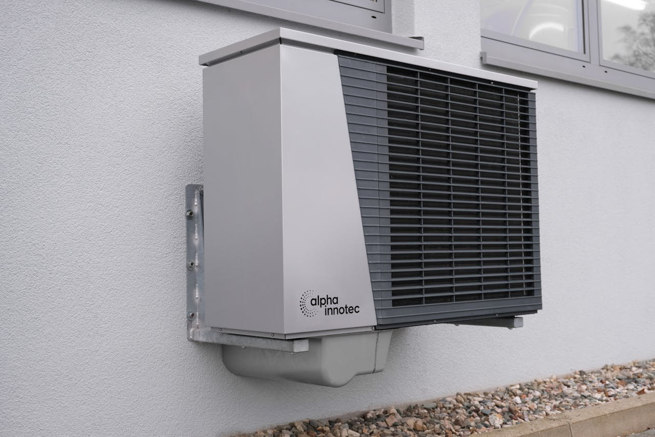 services-04 Outdoor air conditioning unit mounted on a residential building exterior.